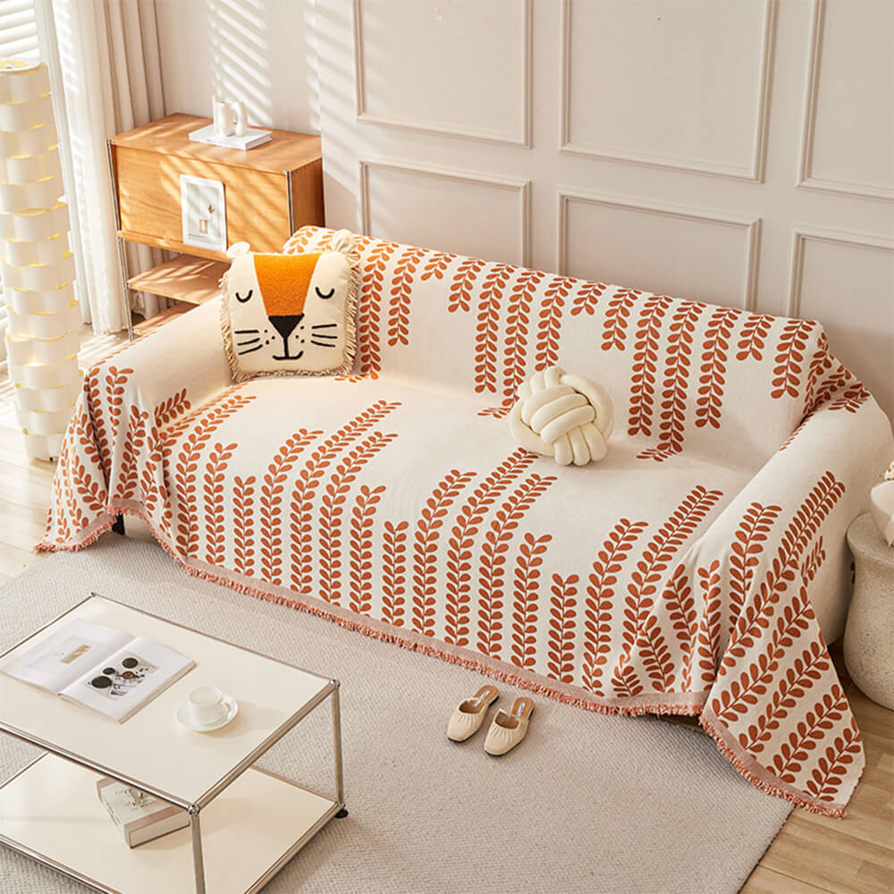 Sofaovertrekk med bladmønster og frynser – eleganse og komfort 